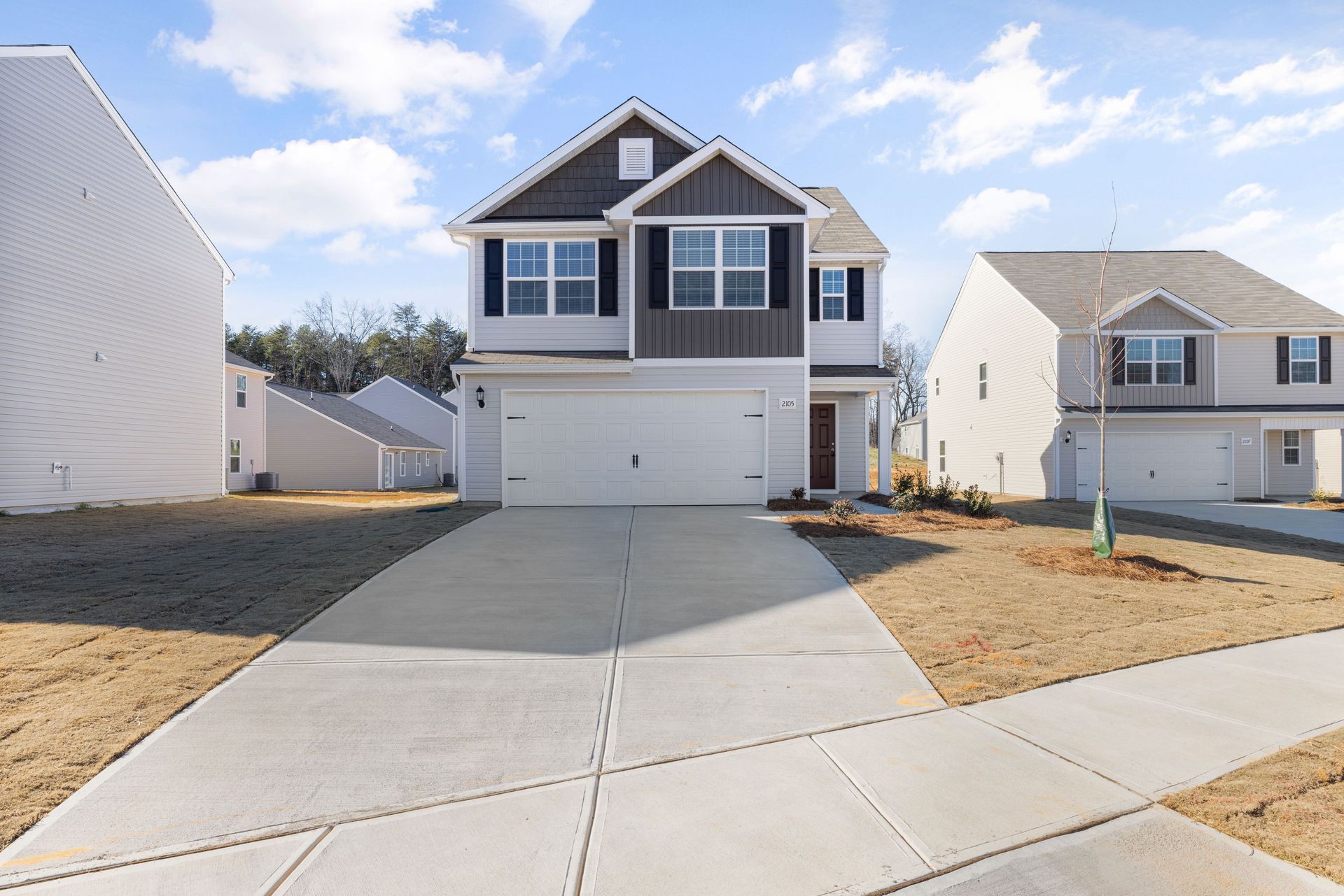 Spacious two-story house with a modern facade in a suburban neighborhood.